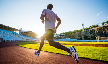 a man running on a sports track.