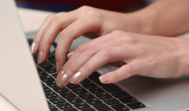 User resting hands on laptop.