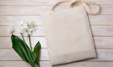 a reusable shopping bag next to a flower