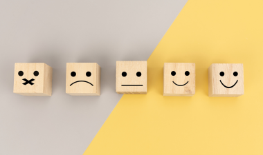 blocks with faces ranging from unhappy to sad when viewed from left to right.