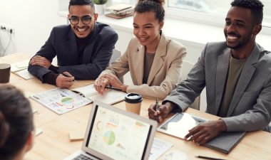 young professionals having a meeting around a laptop.