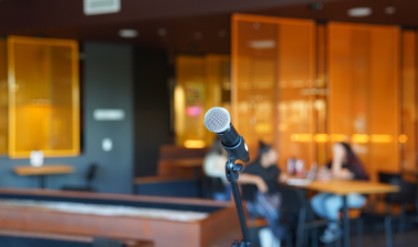 a microphone on stage with a blurry couple in the background.