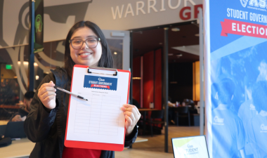 A student holding an ASI Student Government Ballot.