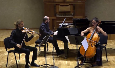 the Galan Trio musical performers, playing their instruments on stage.