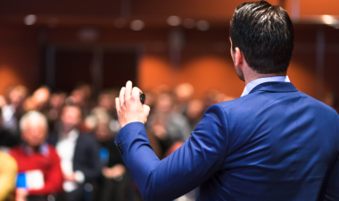 a businessman giving a presentation to a small crowd