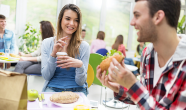 two students eating lunch at a table.