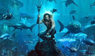 aquaman the character, with sharks swimming behind him