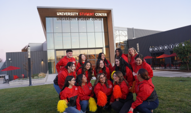 A group of students in a group photo in front of the Student Center.