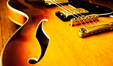 Close up image of a jazz guitar.