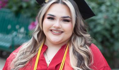 Aleesa smiling with Grad cap on