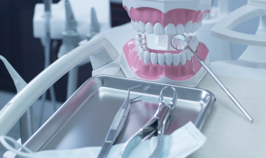 dental equipment on an exam table with a model set of teeth