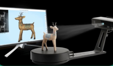 a small toy deer being 3d scanned onto a computer screen