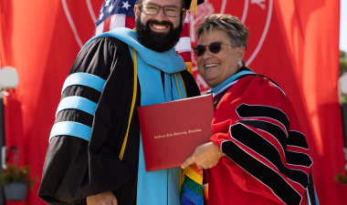 Doctoral candidate with Interim President Borrego in academic regalia