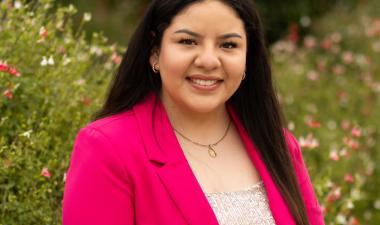 Isabel smiling in a pink blazer