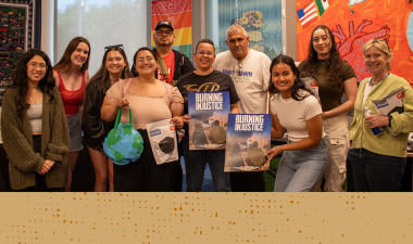 Ten participants from the Burning Injustice screening pose for a group photo.