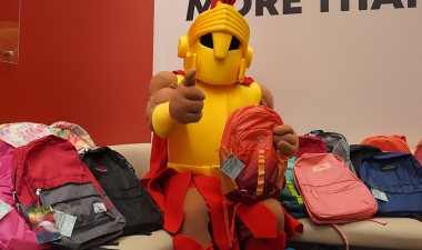 Stanislaus State mascot Titus poses with an assortment of backpacks.