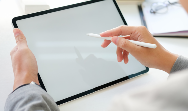 Student holder a stylus drawing on a tablet