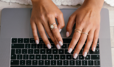 Hands typing on a computer