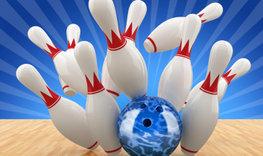 A bowling ball hitting bowling pins