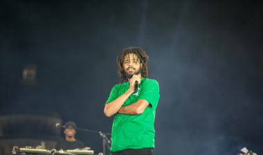 Music artist, J. Cole, on stage performing.