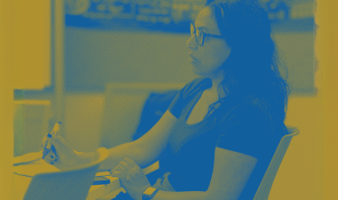 Student seated at an indoor table. 