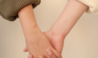 Two individuals holding hands.
