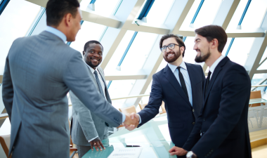 Two men shake their hands.