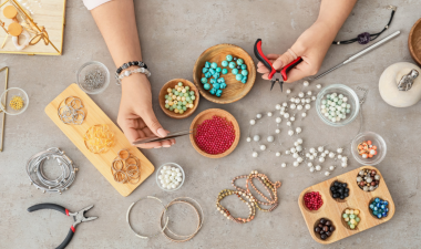 Arial view of someone putting together a beaded bracelet.