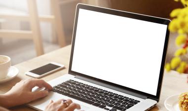 Hands typing on a laptop