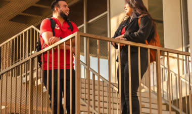 Two students talk while outside.