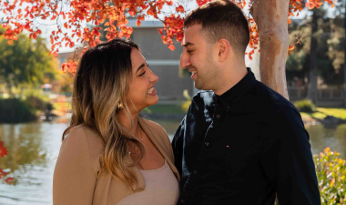 Julian and Juliana Elya gaze romantically into each other's eyes by Village Lake at Stan State