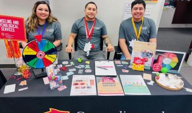 Students sitting at a table with information