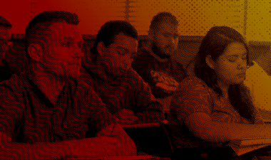 Duotone image of students inside a classroom.