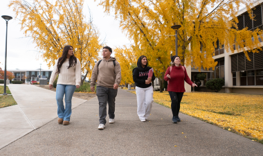 Students walking on campus outdoors.