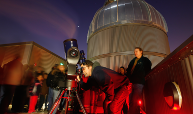 People on the Naraghi Hall rooftop, looking out of a telescope