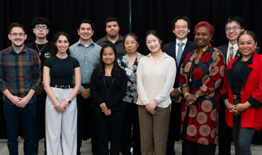 Students, alumni, faculty pose for a picture at Meet the Firms Night.