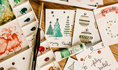 Arts and crafts supplies on top of holiday cards