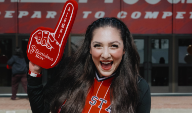 Student cheering with foam finger