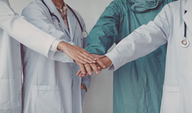 Healthcare workers putting their hands together