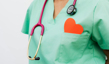 Nurse with scrubs, a stethoscope, and a paper heart