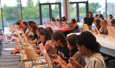 Students are seen painting canvases at a recent paint night event at the Student Center