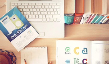 Image of a desk with books and a laptop