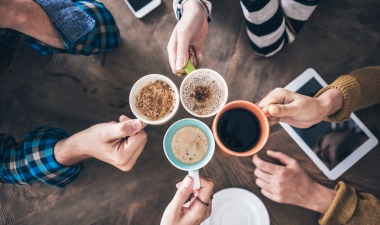 People cheering their coffees together