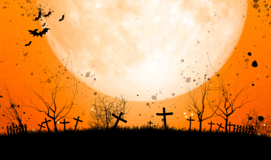 Halloween cemetery scene with moon and bats
