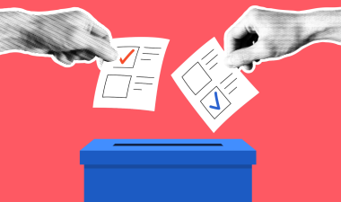 peopel placing their ballot in voting box