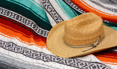 Traditional mexican blanket with hat on top