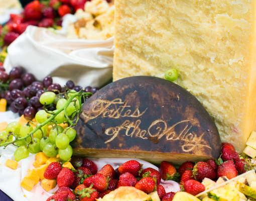 Charcuterie board with &quot;Tastes of the Valley&quot; carved out in a cheese block