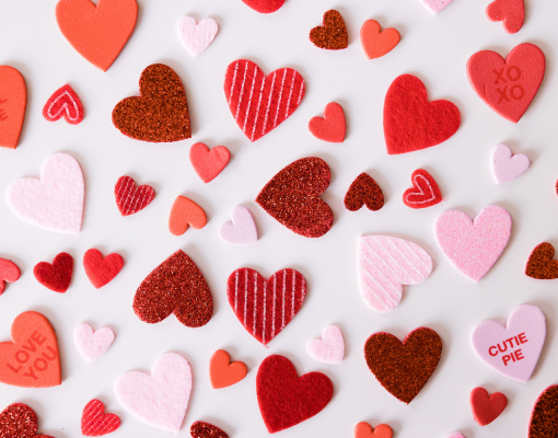 various Valentine Sweetheart heart shaped candies spread across a white background.