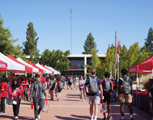 Turlock campus quad with people and tents