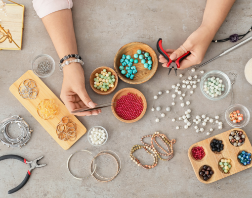 Arial view of someone putting together a beaded bracelet.